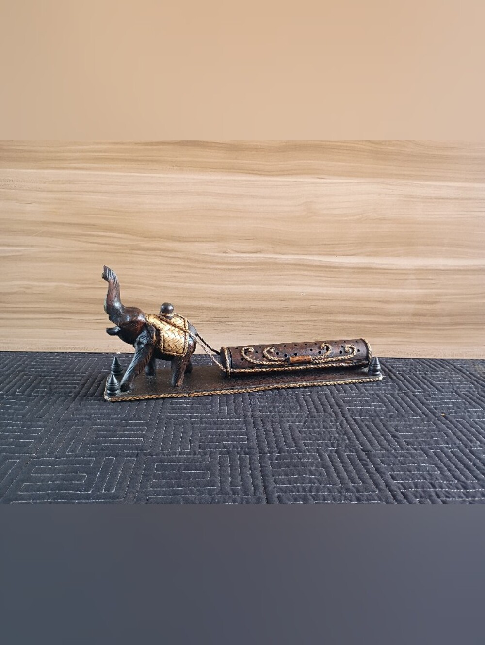 Thai elephant towing a log incense holder